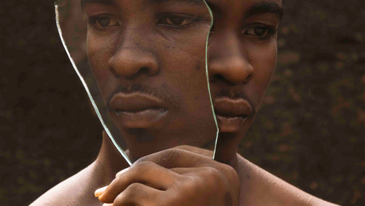 person looking one way and holding a mirror of him looking another way. What Is Self-Discovery and Why It Matters